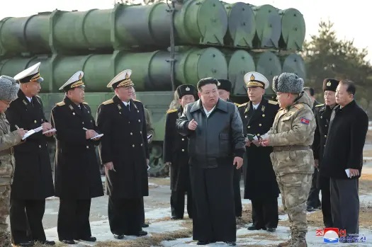 Kim watches missile tests and warns that North Korea will take an aggressive stance in disputed seas