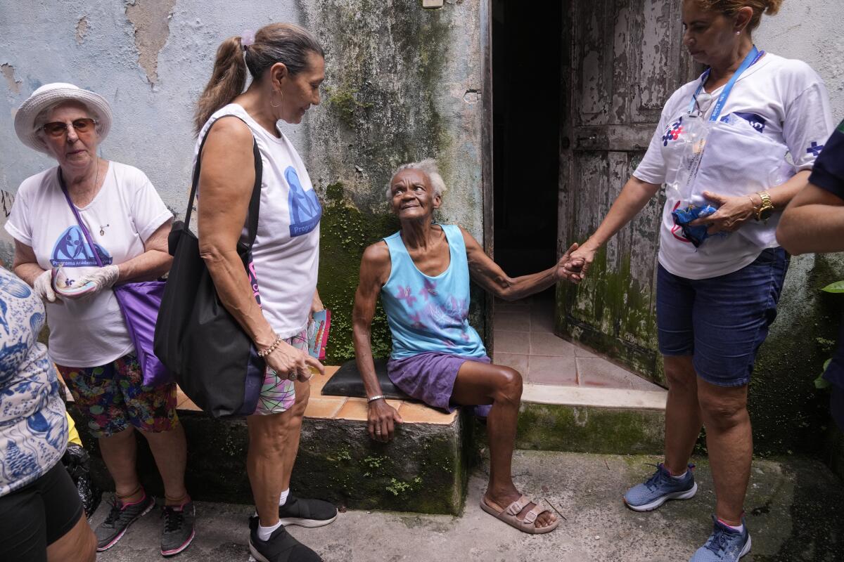 To fight dengue epidemic, health agents in Brazil scour junkyards and roofs for mosquitos